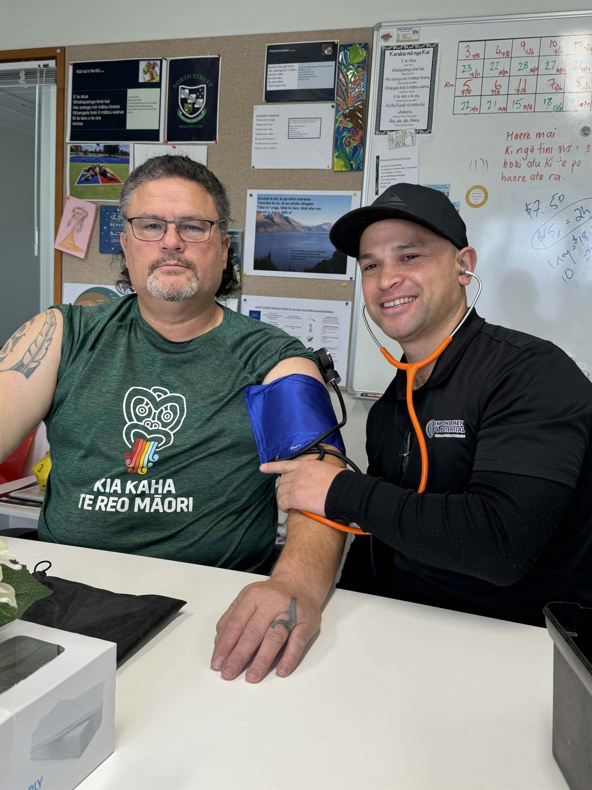 Josh Te Rauna taking a blood pressure reading for a participant at the community health check.